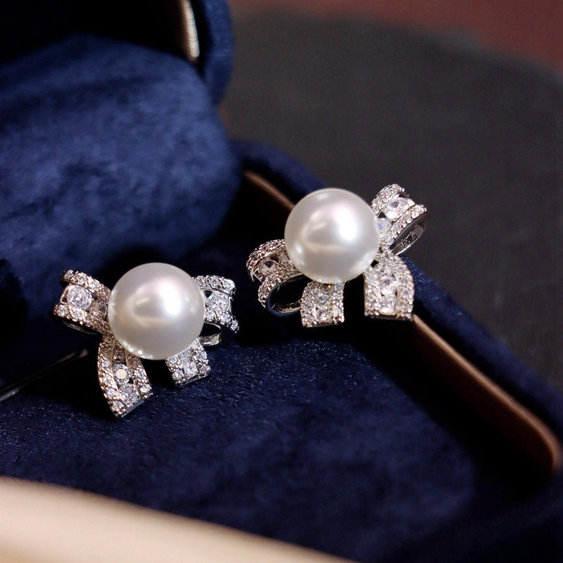 Pearl bow stud earrings by Yoshan