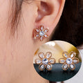 Gold floral stud earrings by Yoshan