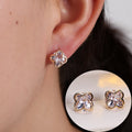 Gold cubic zirconia floral stud earrings by Yoshan