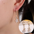 Gold cubic zirconia floral stud earrings by Yoshan