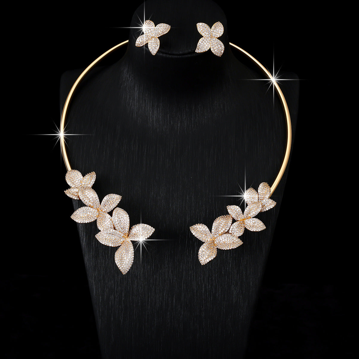 Gold cubic zirconia floral earrings by Yoshan