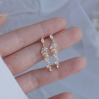 Gold cubic zirconia tassel stud earrings by Yoshan, view 2