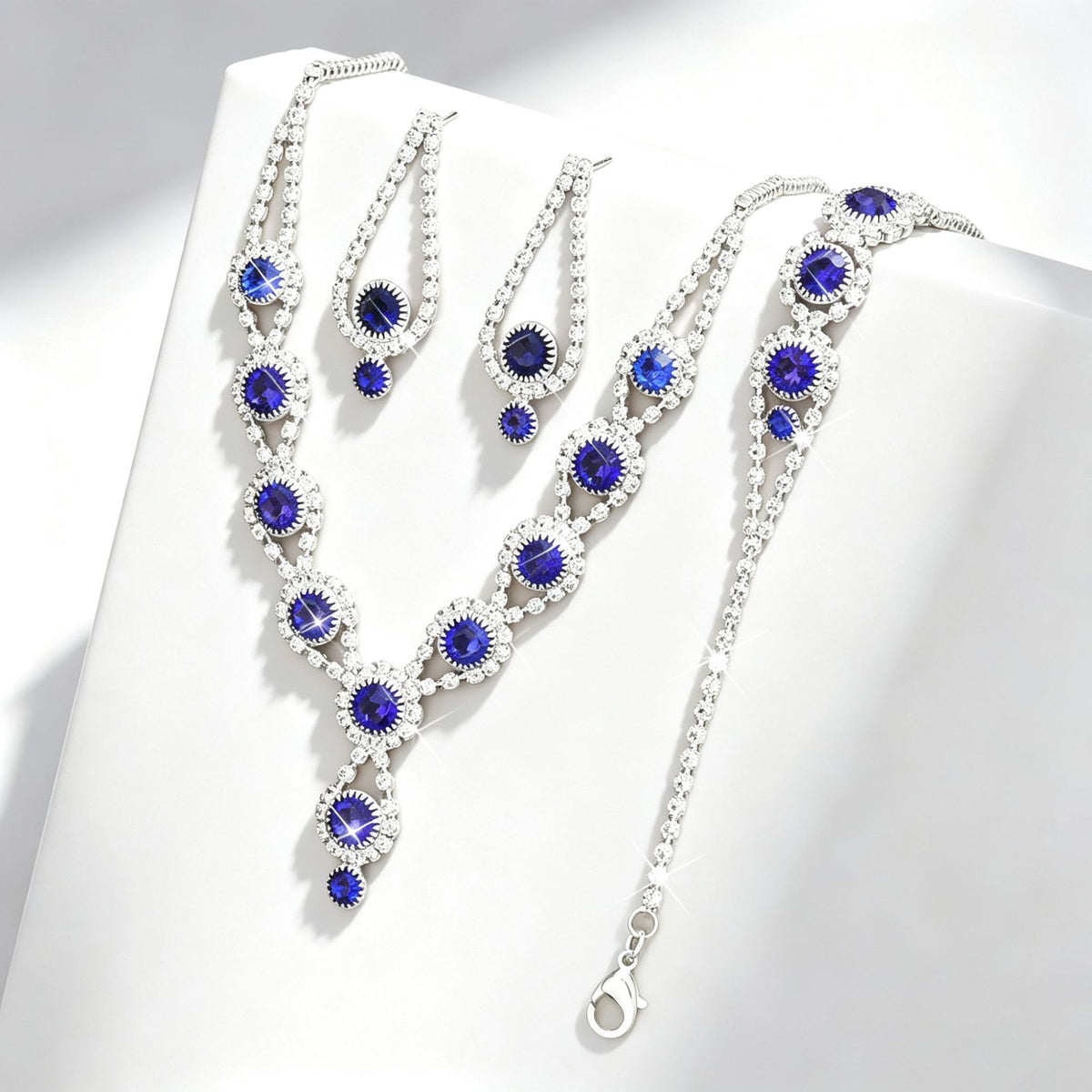 Blue crystal geometric drop earrings by Yoshan