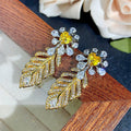 Yellow cubic zirconia floral stud earrings by Yoshan