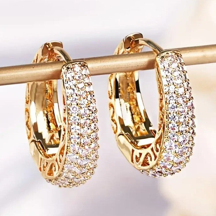 Gold crystal cutout earrings by Yoshan