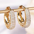 Gold crystal cutout earrings by Yoshan